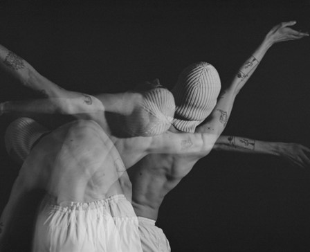 A black and white artistic photo of a person moving in front of the camera