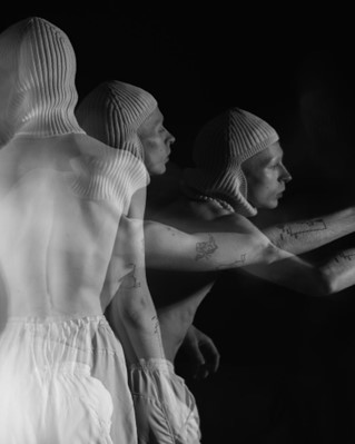 A black and white artistic photo of a person moving in front of the camera