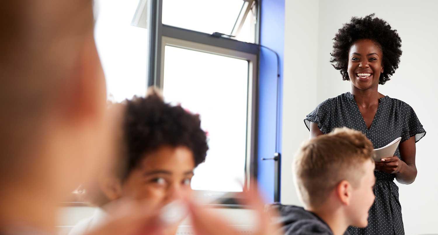 A teacher smiles at her class