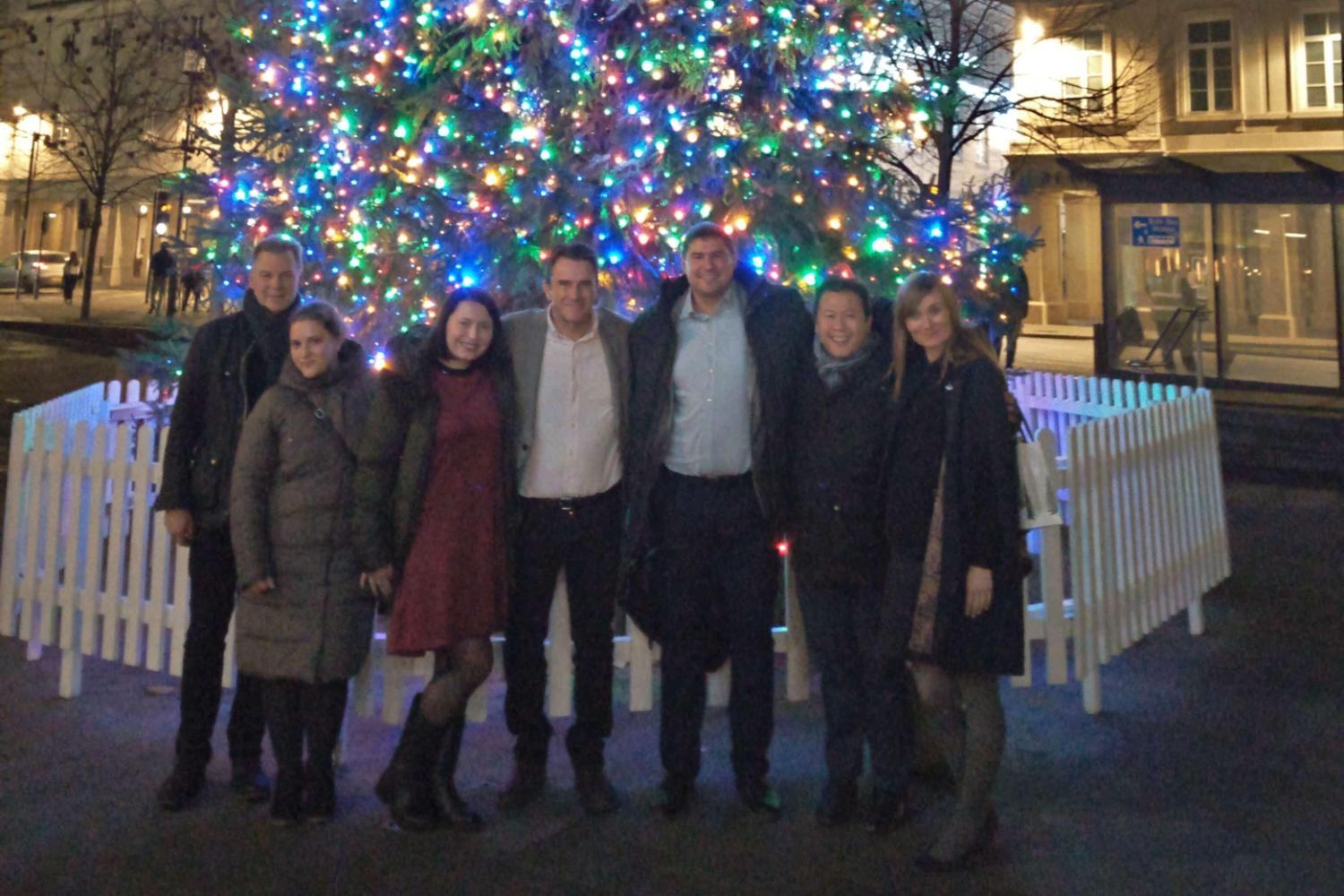 Visitors from Ukraine stand in front of the Christmas tree outside Bath Spa Station