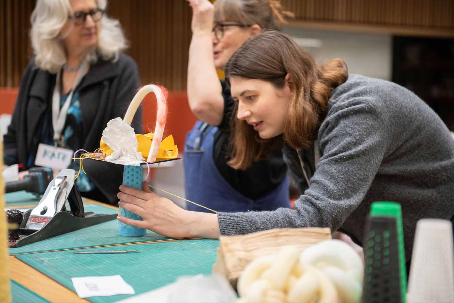 People around a table crafting