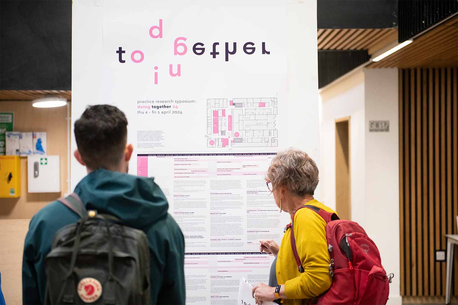 People looking at a board with lettering