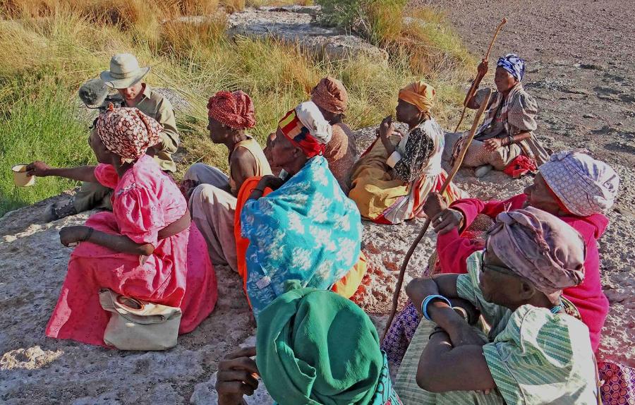 Group of women in Namibia sitting around a spring.