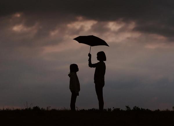 Adult and child with umbrella2