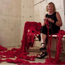 Lou Baker surrounded by her knitting