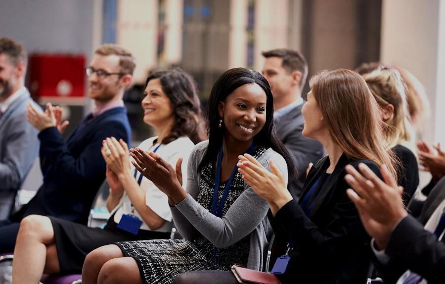 Audience applauding speaker after conference presentation