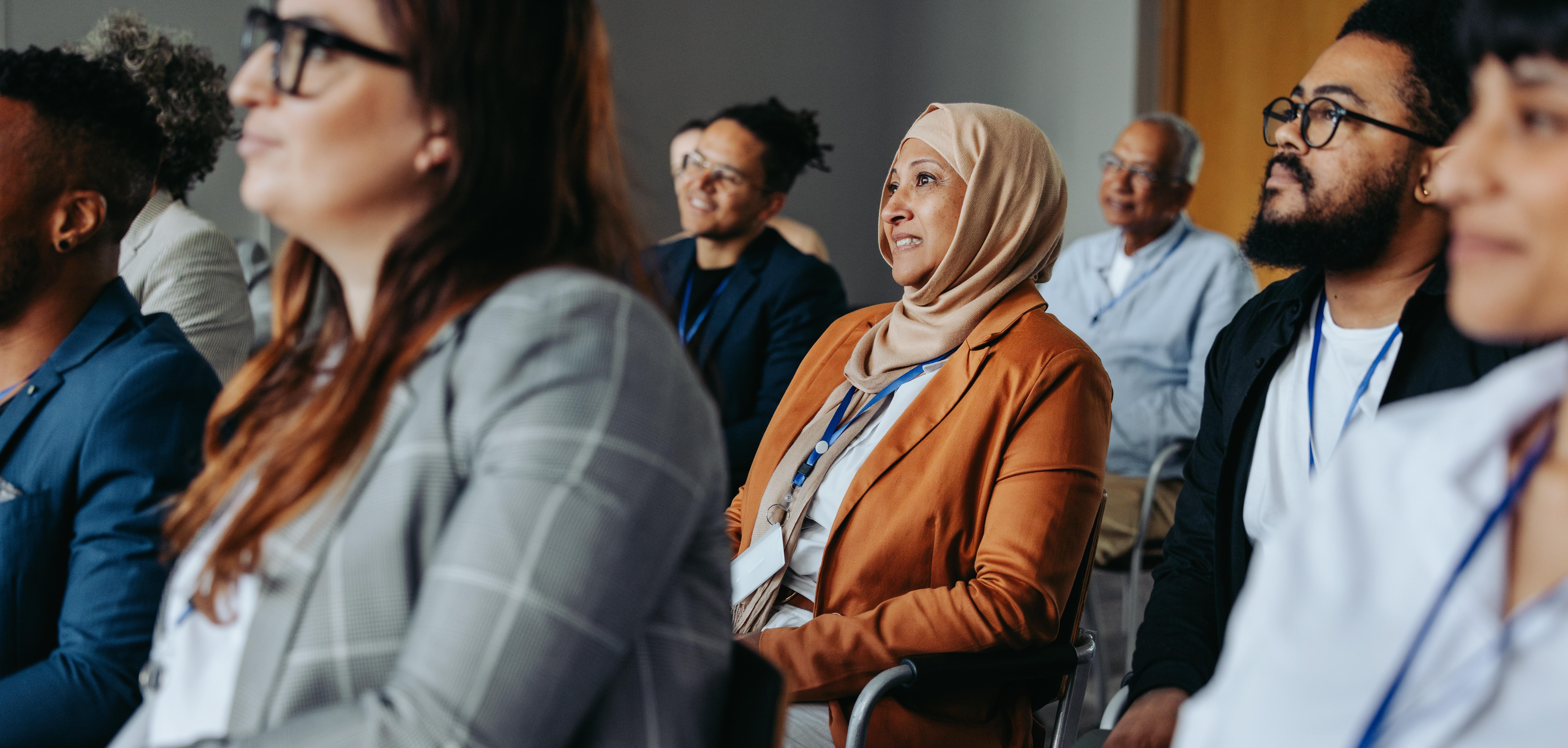 A seated audience listening to a speaker