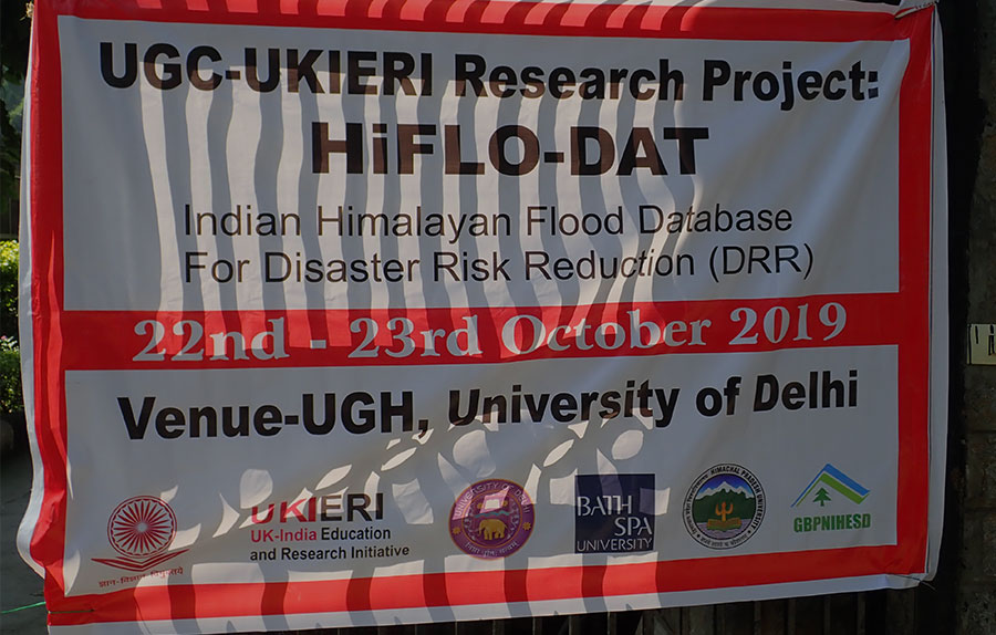 A black, white, and red poster announcing a conference in India