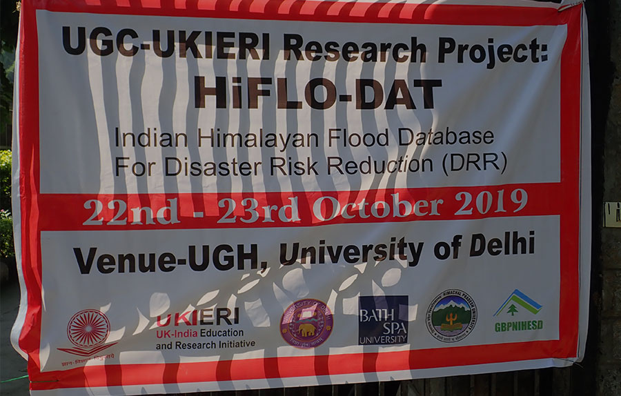 A black, white, and red poster announcing a conference in India