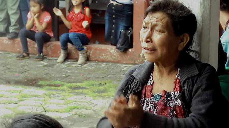 Woman clapping with children in the background