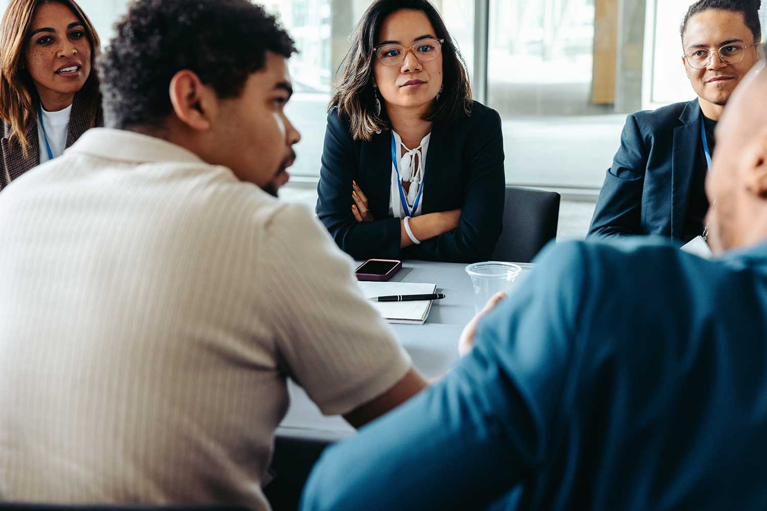 Colleagues sit around a boardroom table