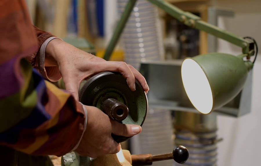 A student using machinery in a workshop.