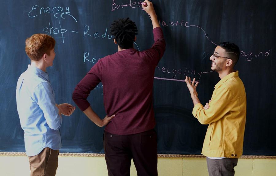 Student writing on a blackboard