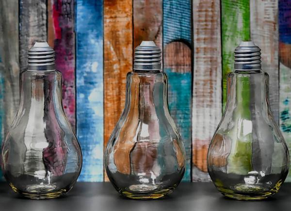 Light bulbs standing upside down on a table with a bright background.