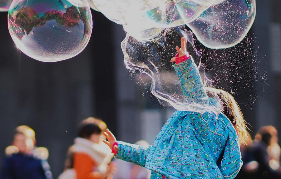 Child playing with bubbles