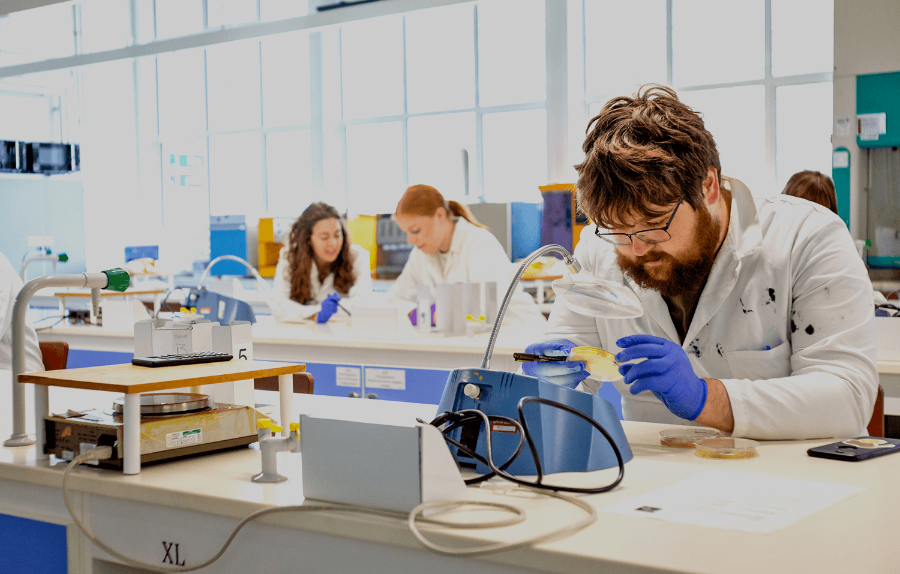 A student using science equipment in a biology lab