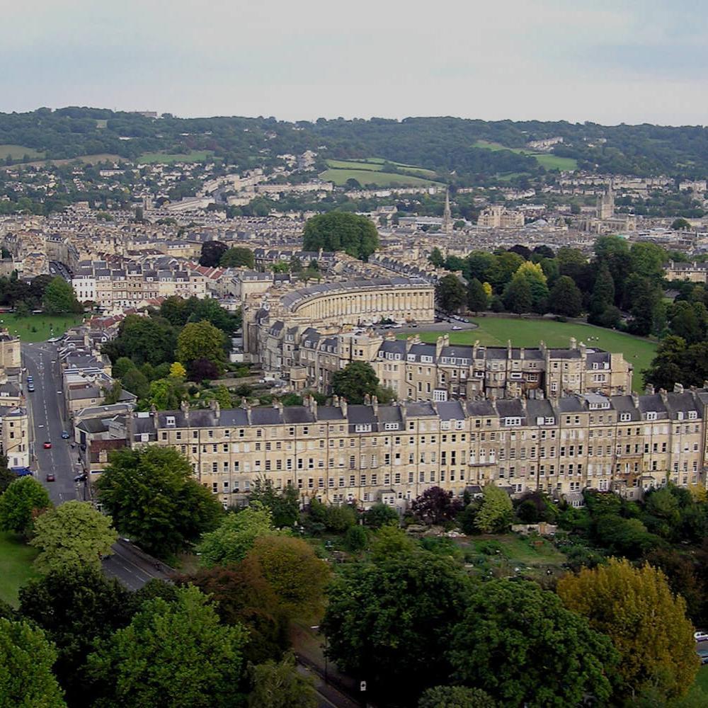 Aerial view of Bath showing buildings and green space.