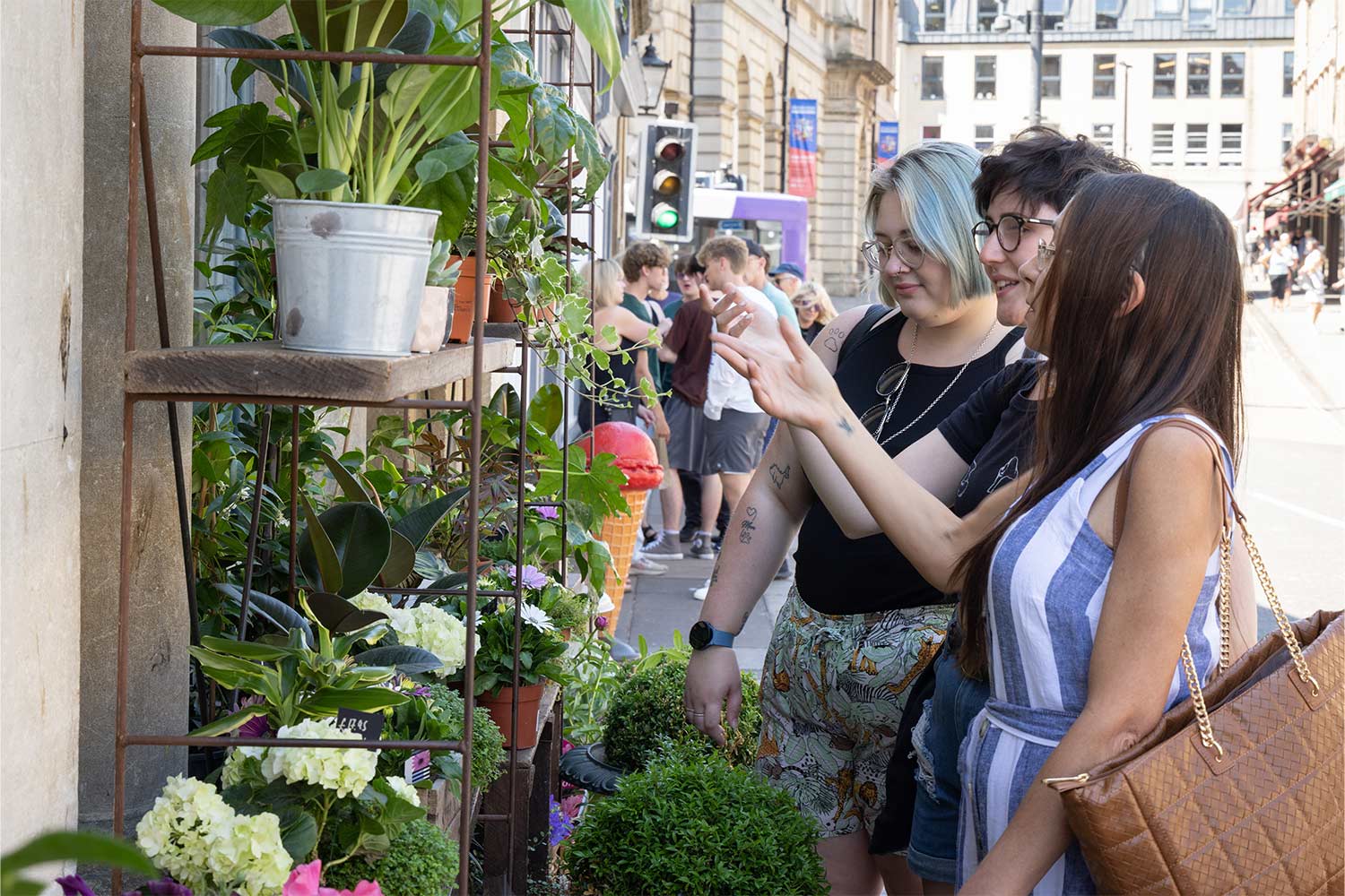 Group of young people in front of a plant display in Bath