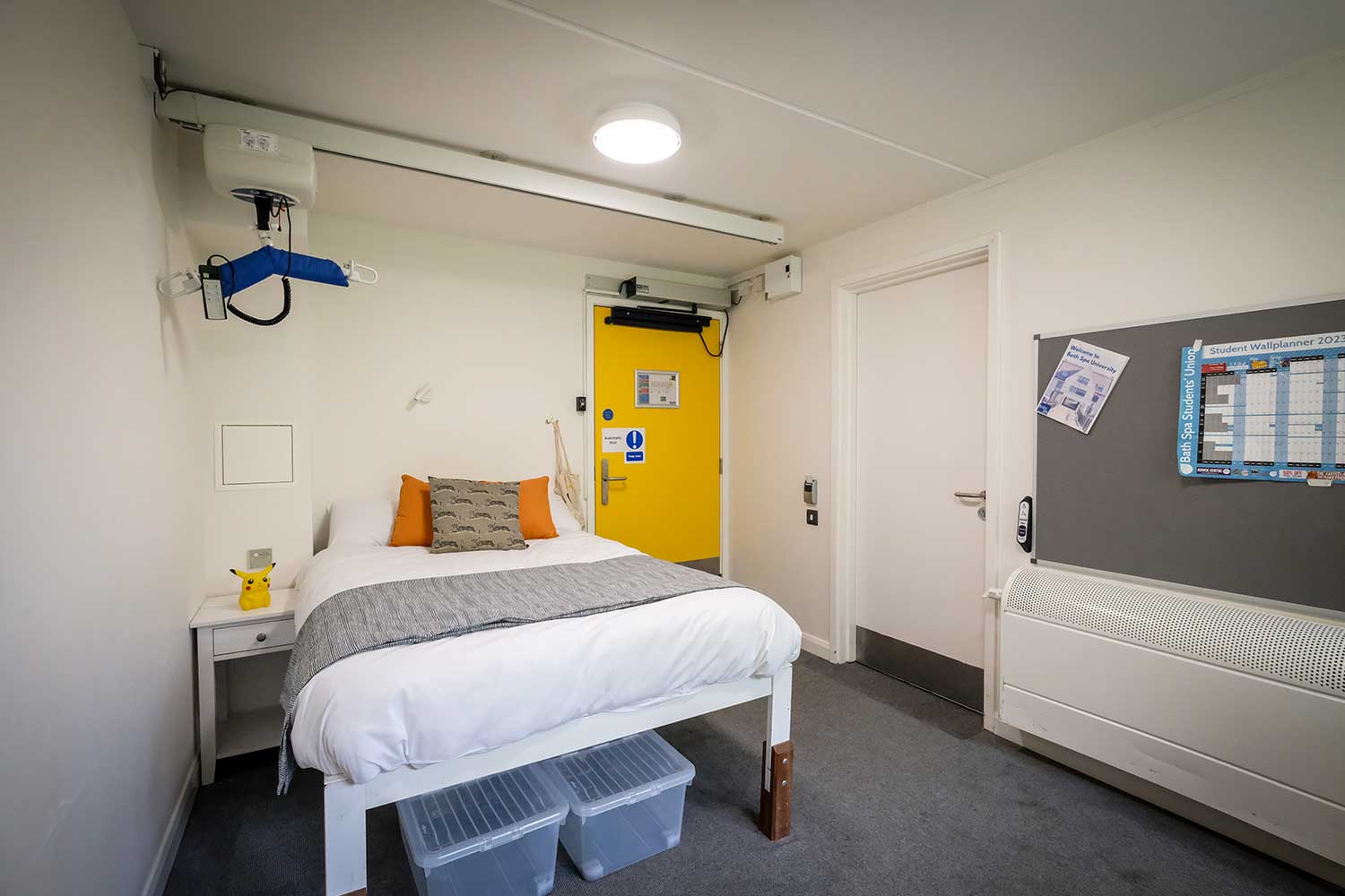 A large bedroom equipped with a hoist above the bed