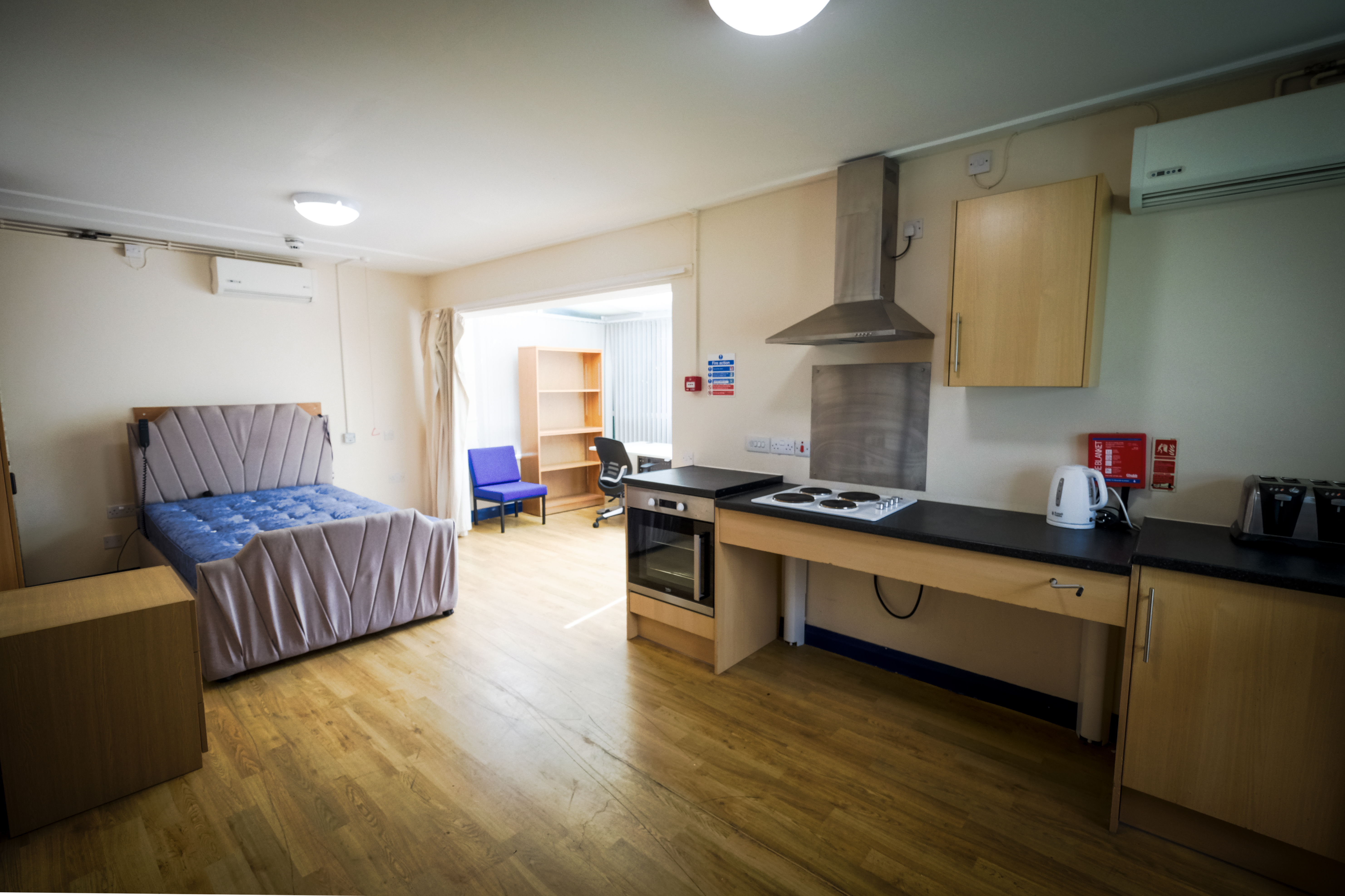 A large private flat on a level surface with kitchen cabinets made accessible to wheelchair users