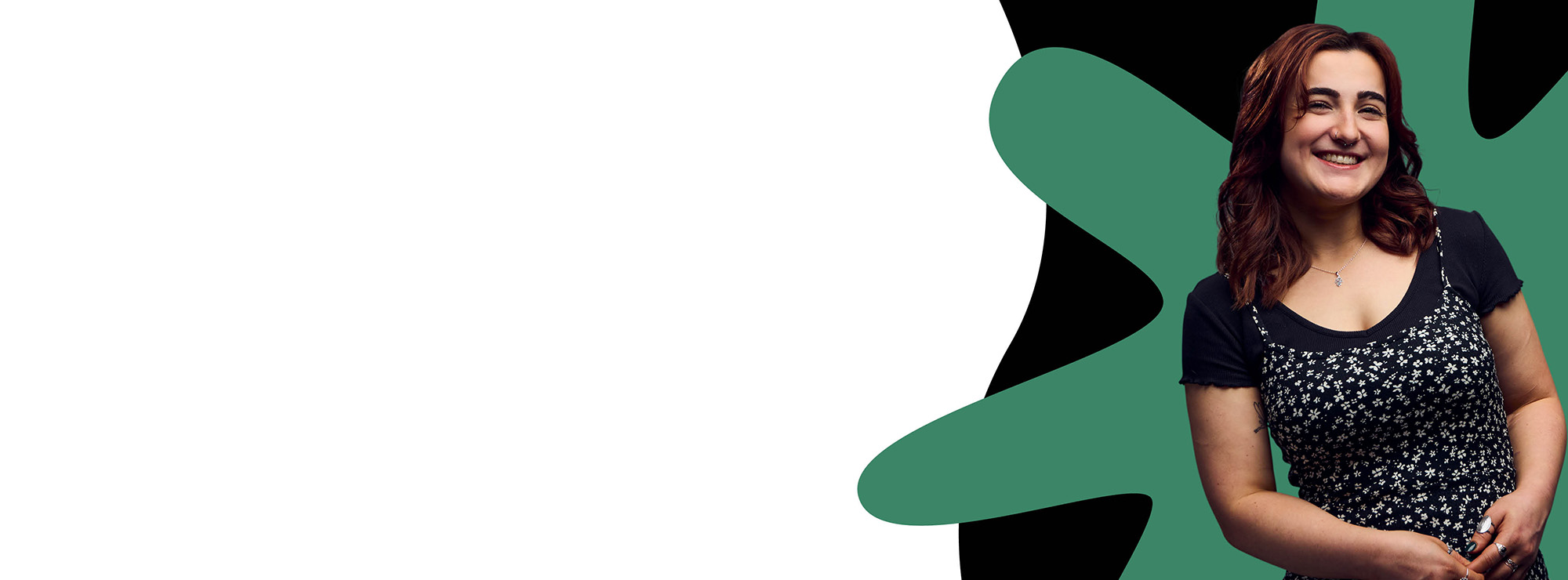 A smiling Bath Spa student stands on the right side of the image against a background of green and black paint.