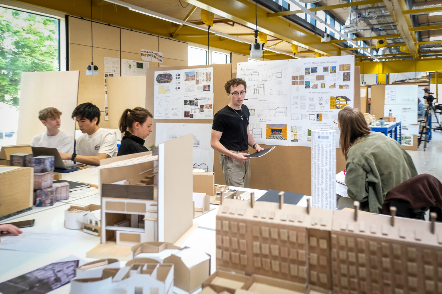 Students watch as another student presents their work