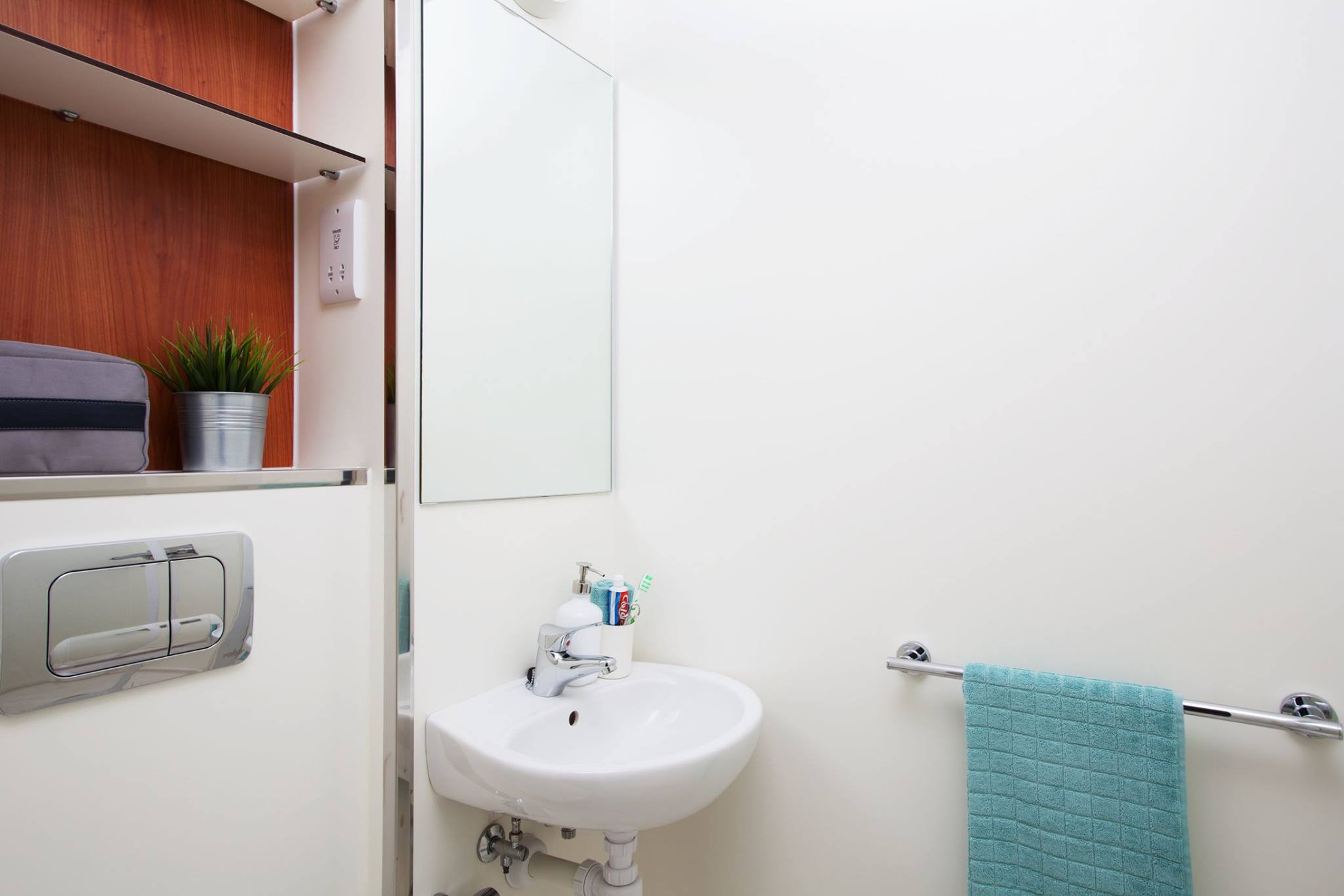 A basic bathroom with toilet, shower and sink