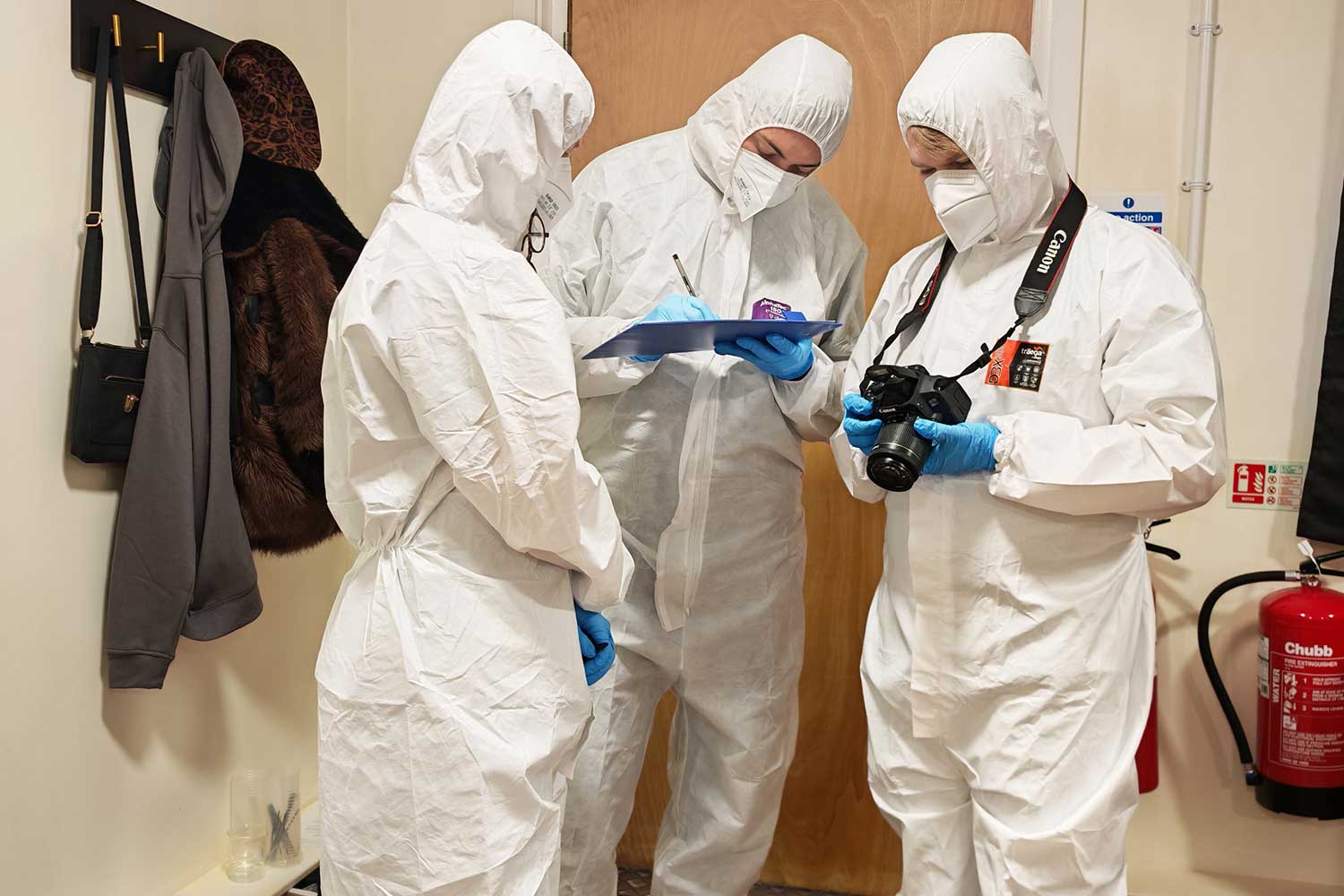 Three students dressed in PPE