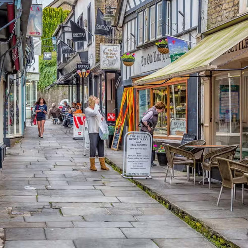 Busy cobbled street lined with cafes