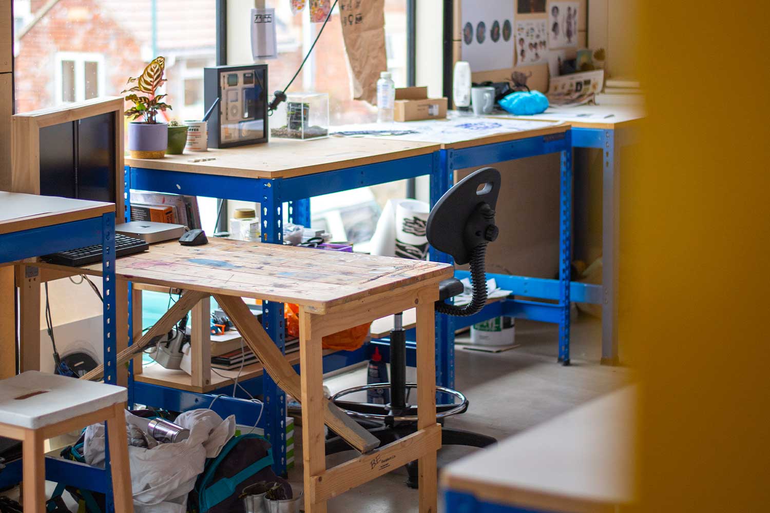 An artist's desk facing a large window