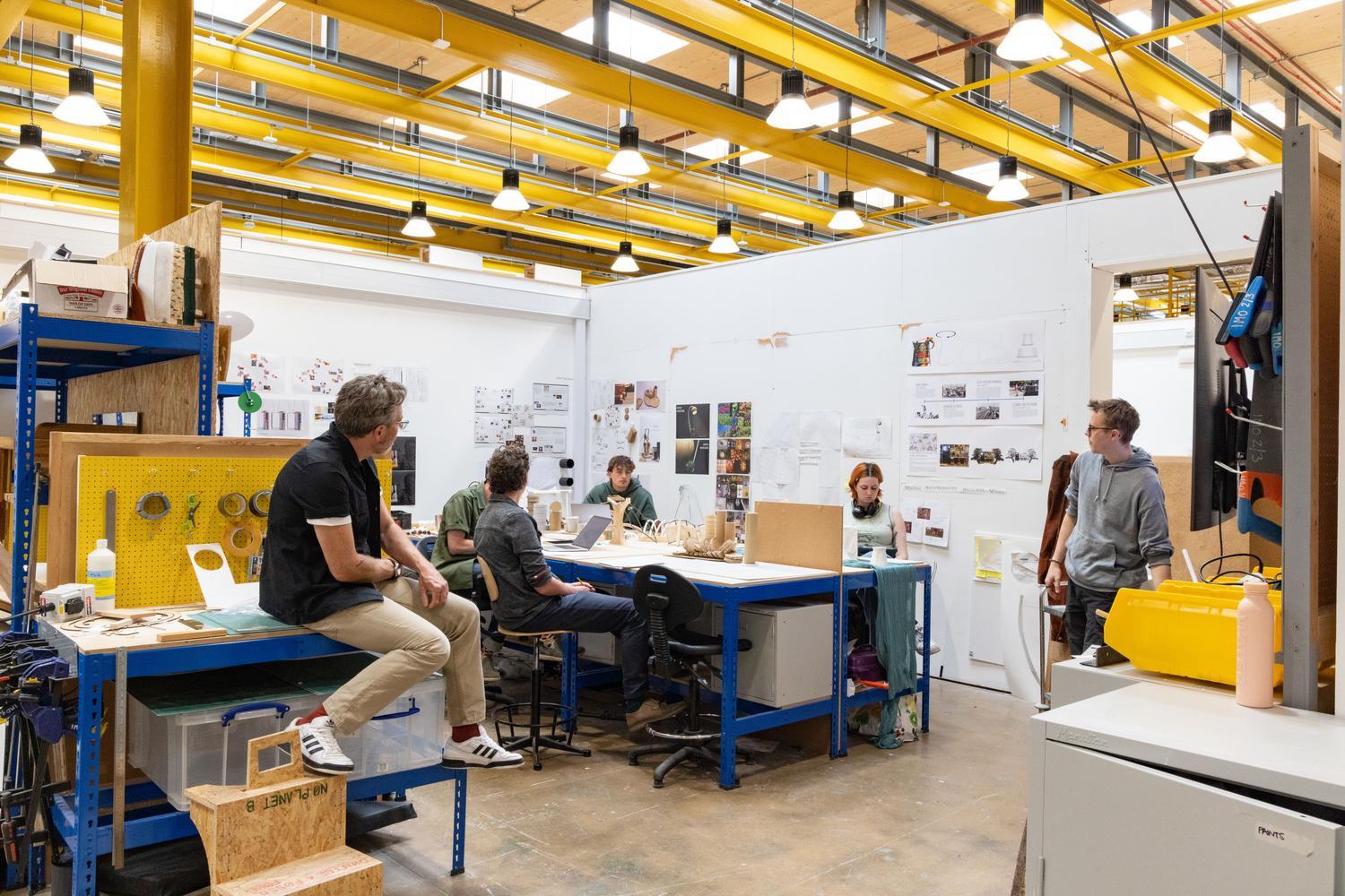 Students and staff share ideas in an open plan room