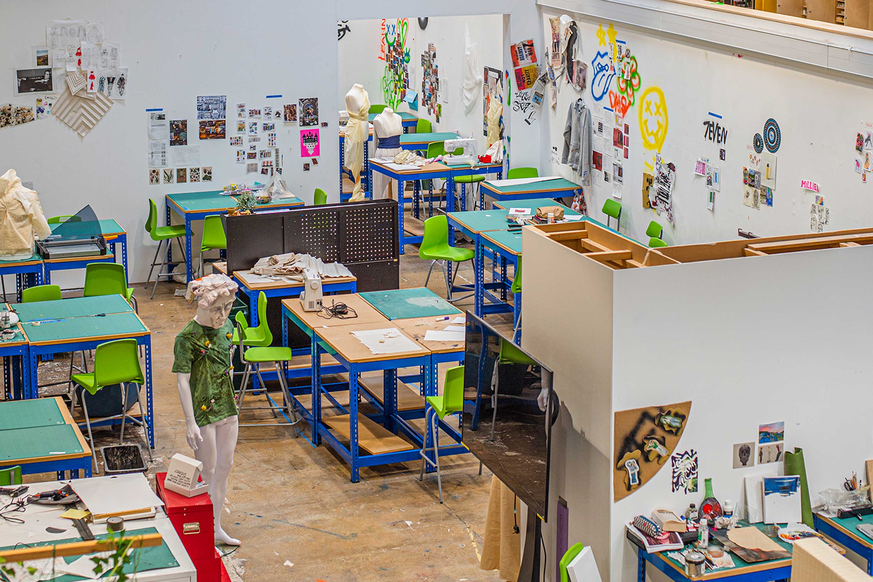 A large open plan space filled with artist's desks