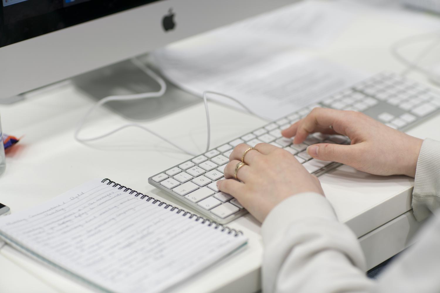 Close up of a person on an Apple Mac keyboard