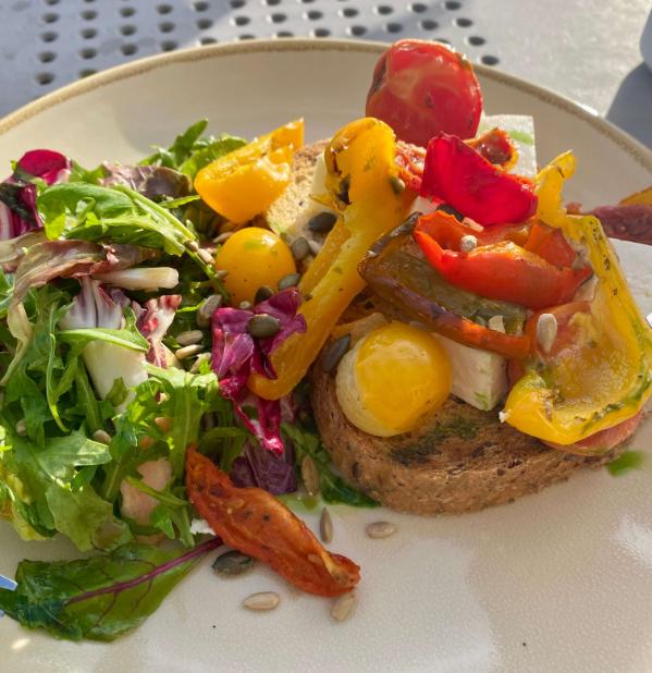 A colourful plate of food on an outdoor table