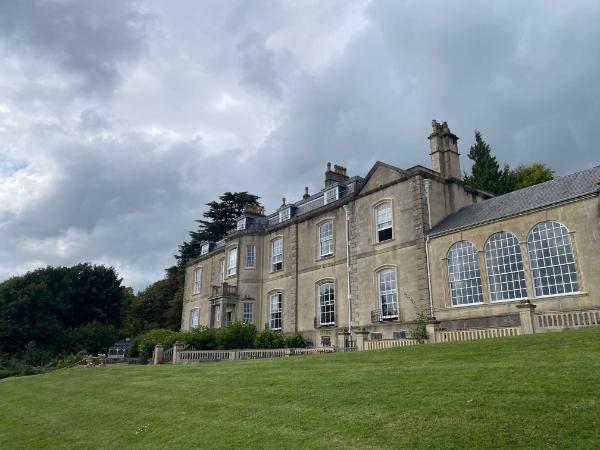 A manor house surrounded by green grass