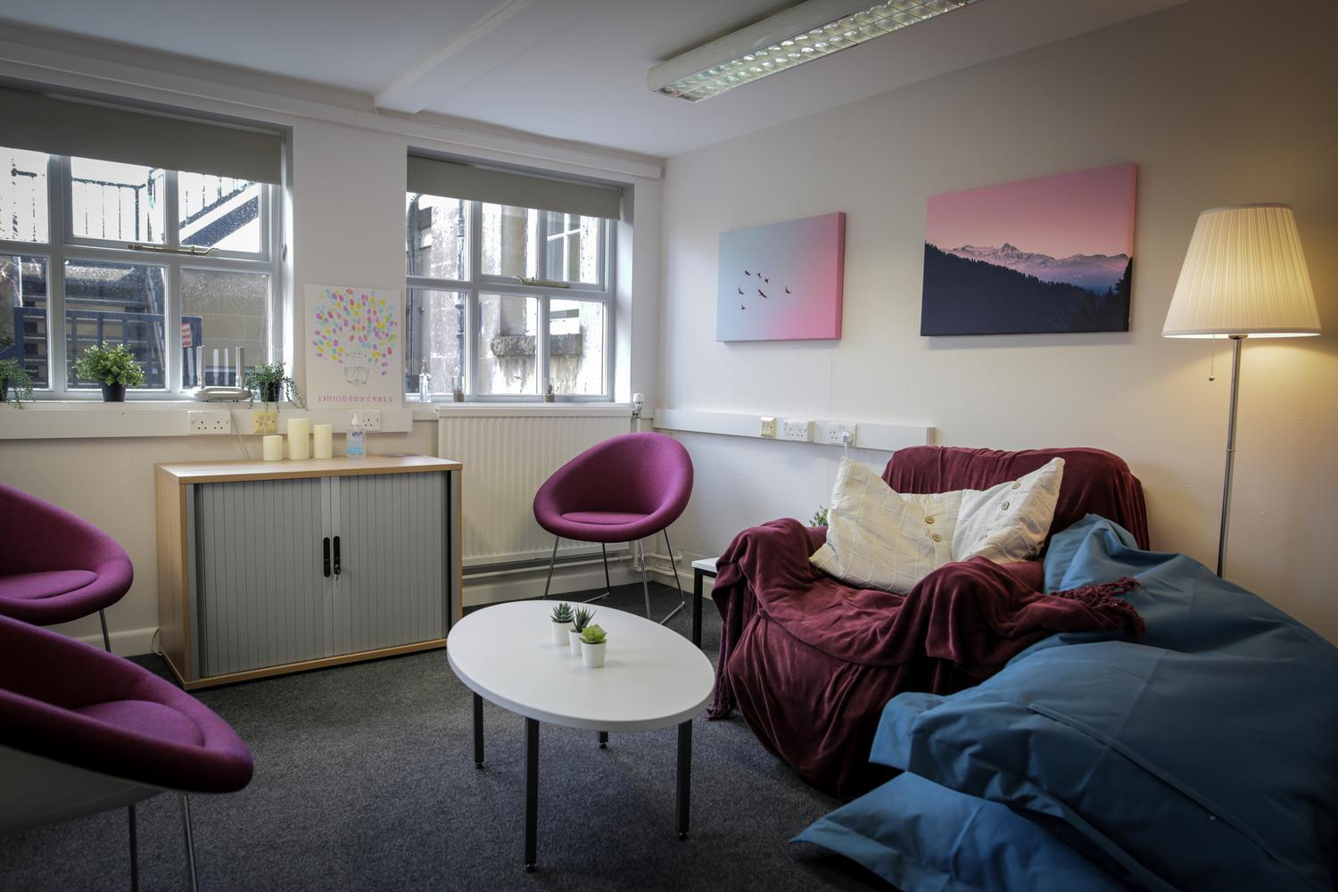A room with sofas, armchairs and a coffee table
