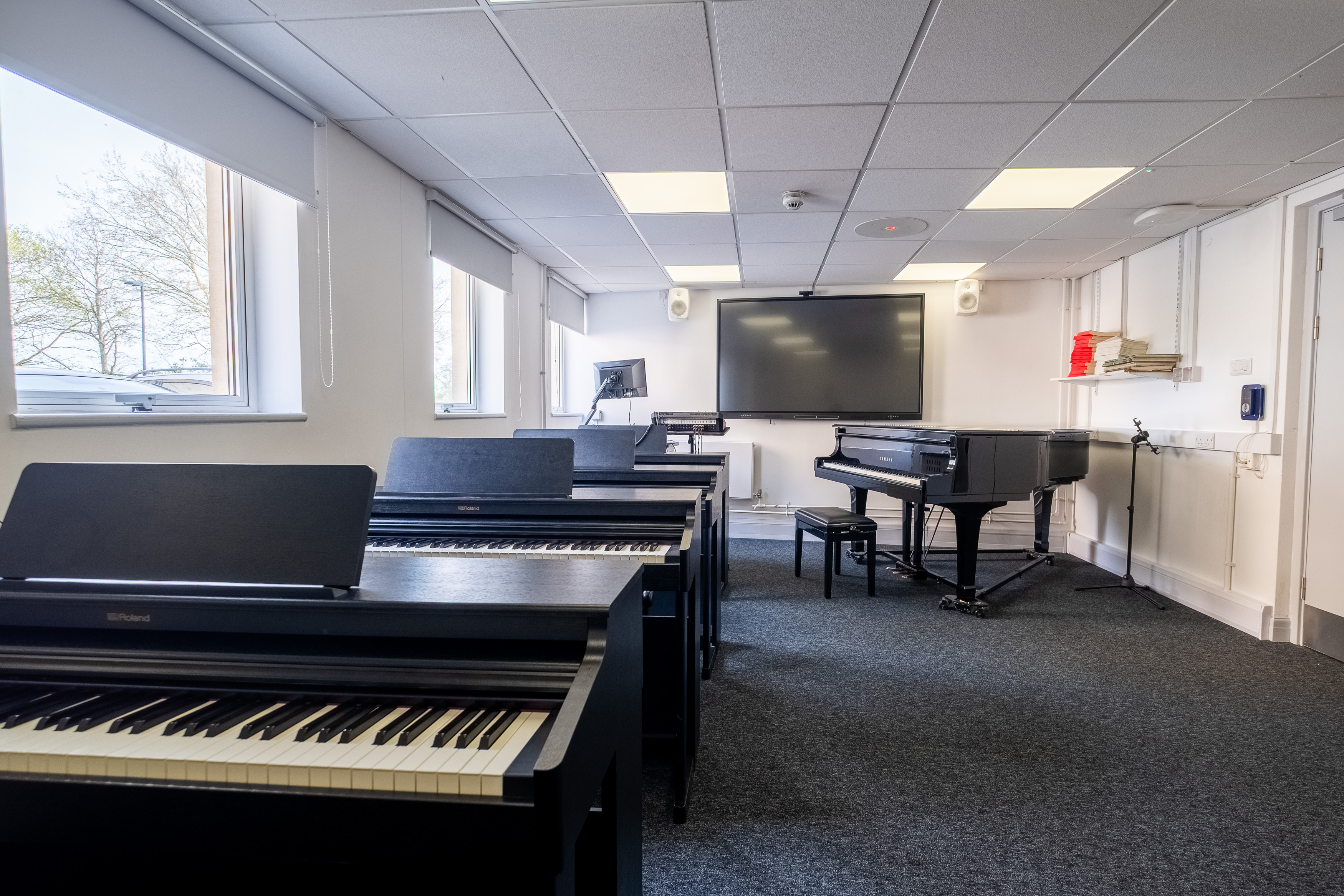 Four pianos in a small room