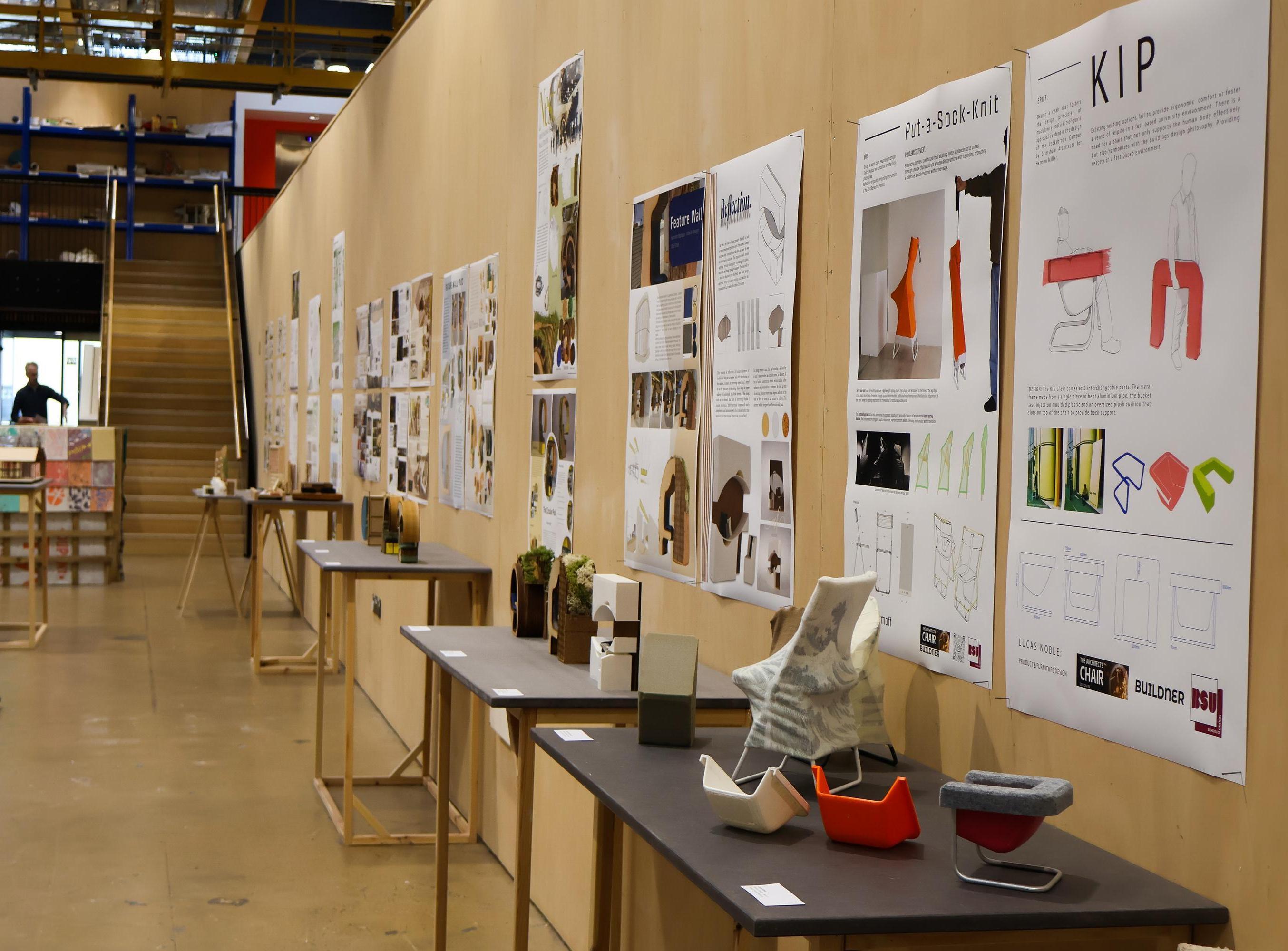 A large open corridor with artwork on display on one wall