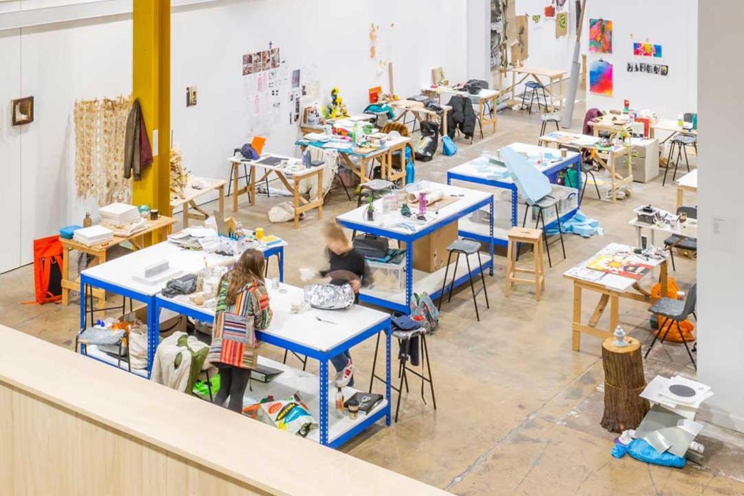 A large open-plan space with desks assigned to each student