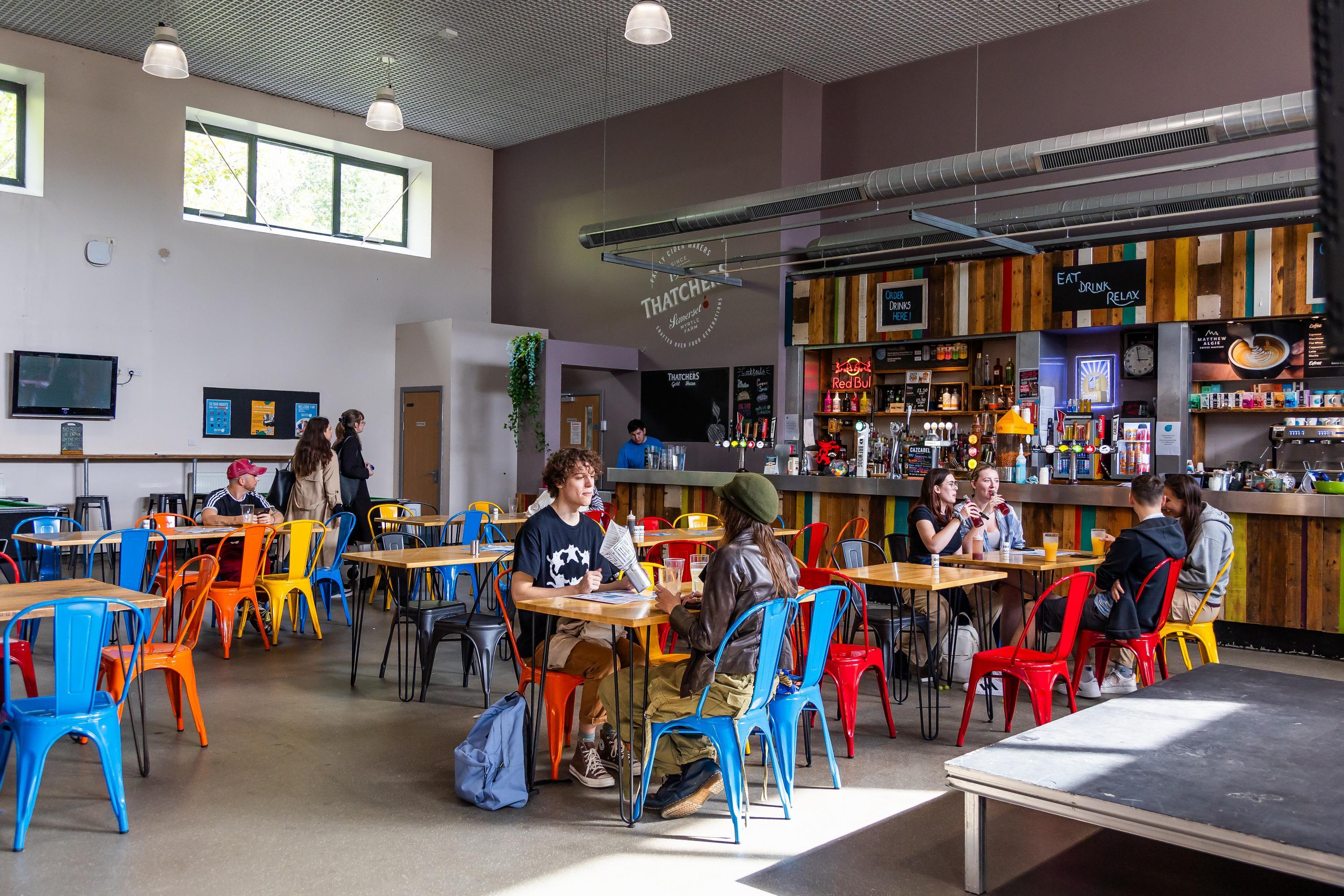 A student bar with colourful chairs and tables