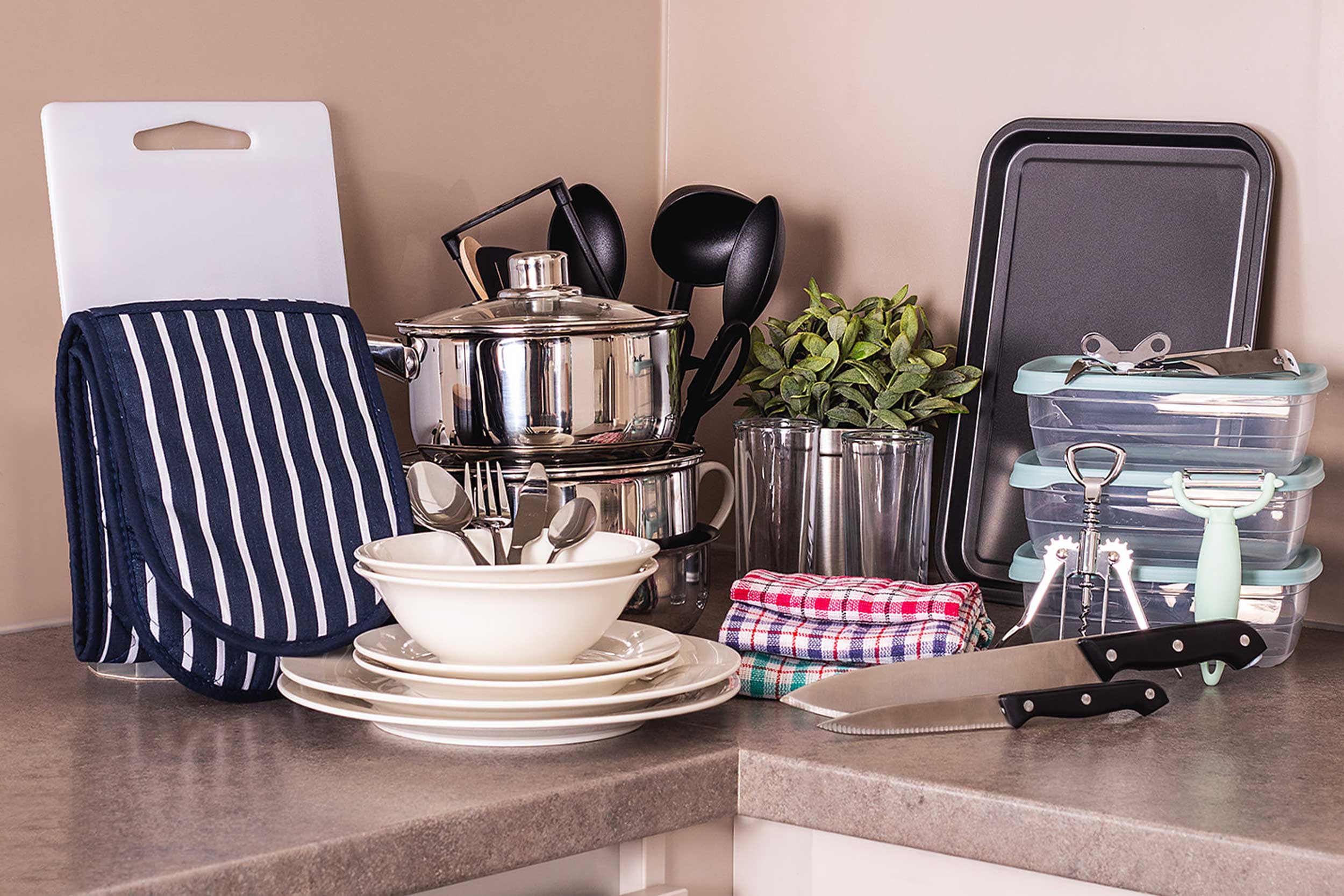A collection of kitchen utensils and crockery on a kitchen work surface