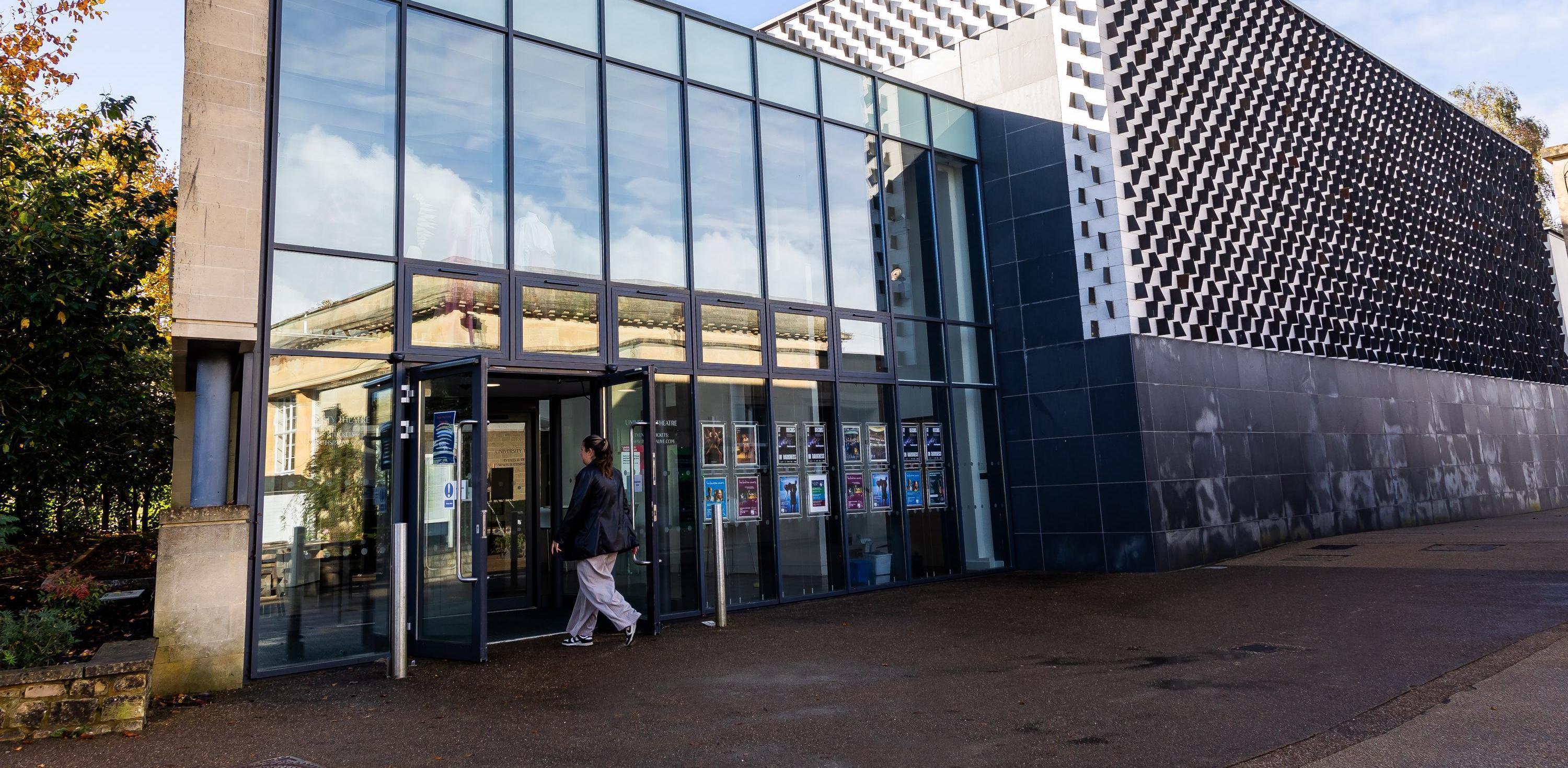 A geometric building with large glass windows and doors