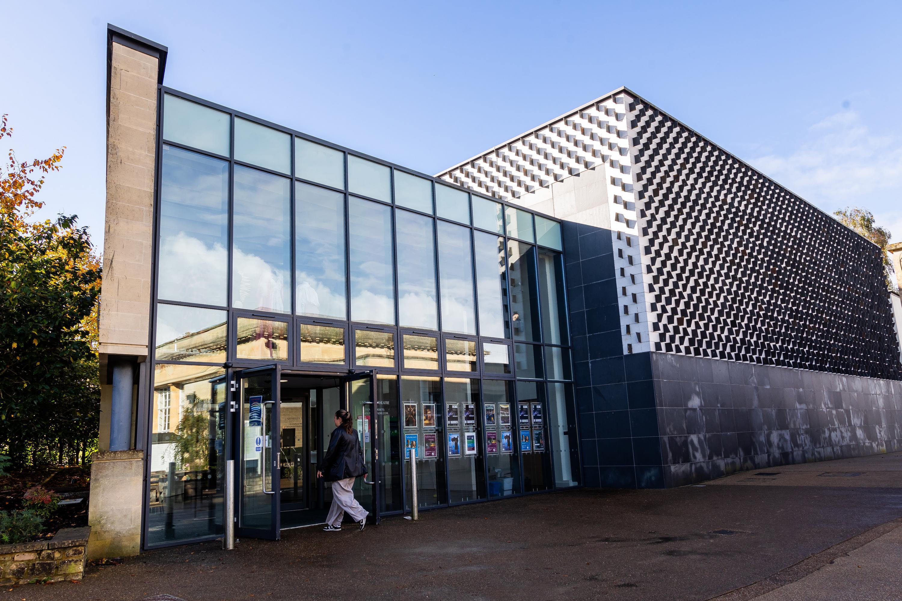 A geometric building with large glass windows and doors
