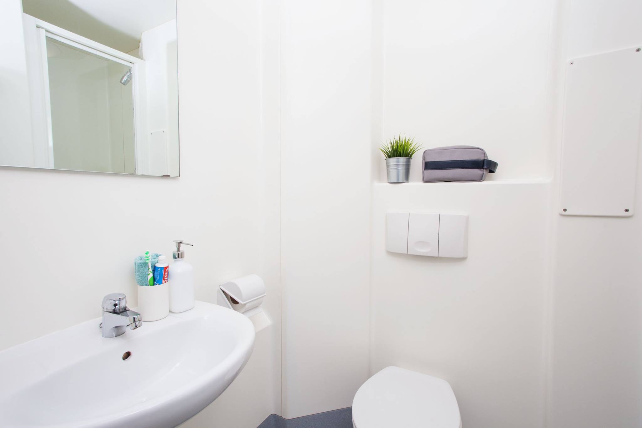 A basic bathroom with toilet, shower and sink