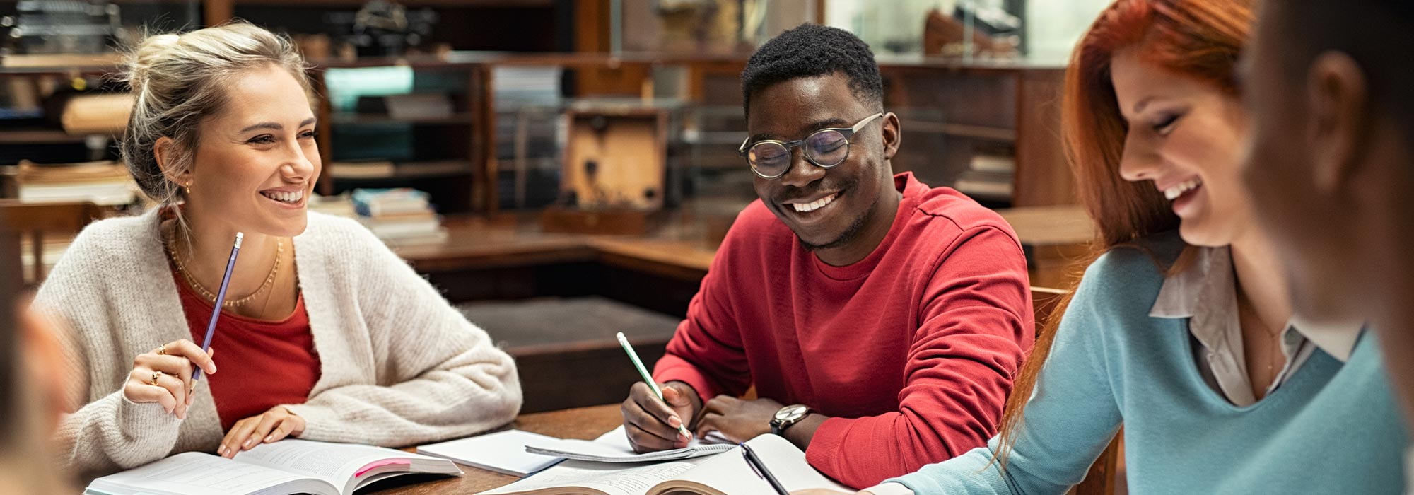 Group of young people studying and laughing