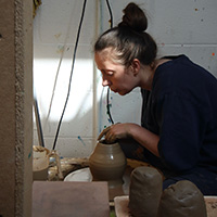 A student making pottery.