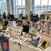 A Bath Spa Student sells from a stall.