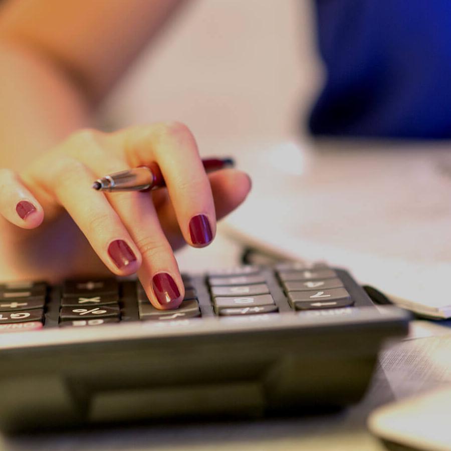 Someone using a calculator on a desk