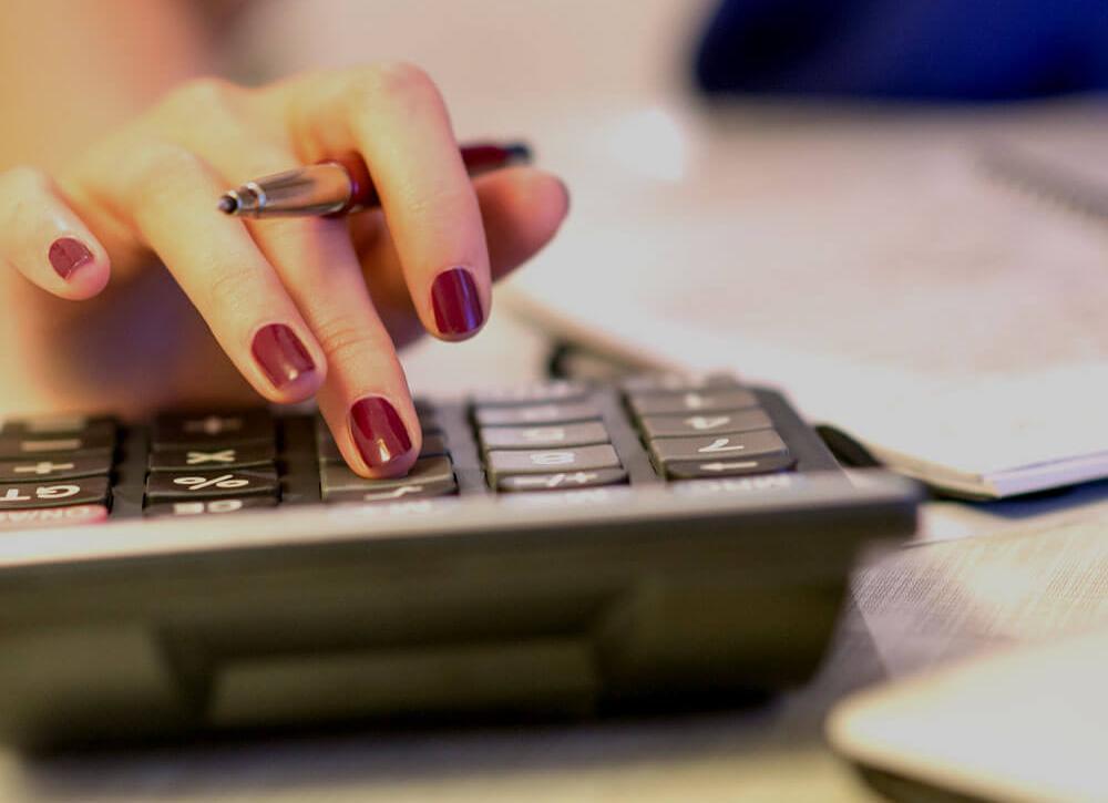 Someone using a calculator on a desk