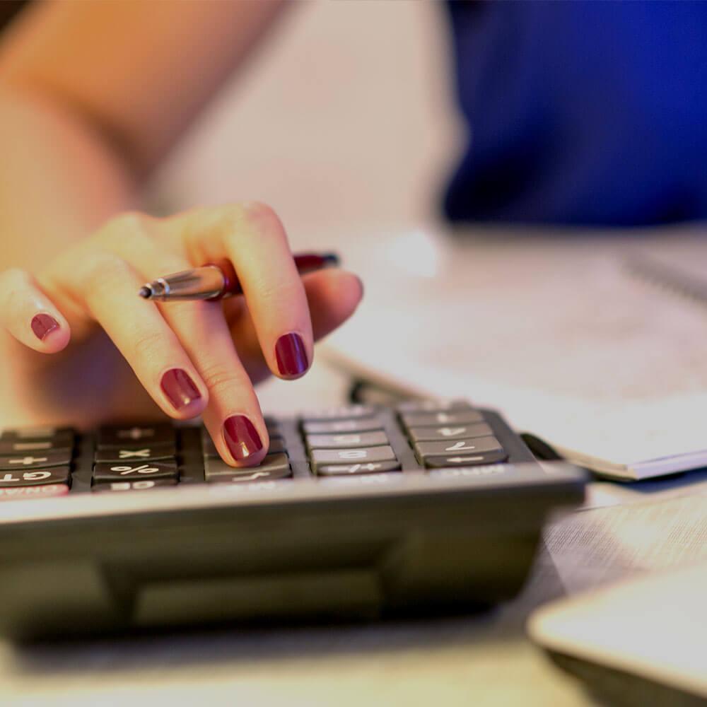 Someone using a calculator on a desk